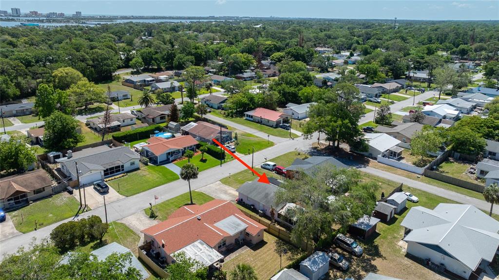 An aerial view shows a residential neighborhood with several single-story houses and surrounding trees — 1107 4TH STREET, PORT ORANGE, FL
