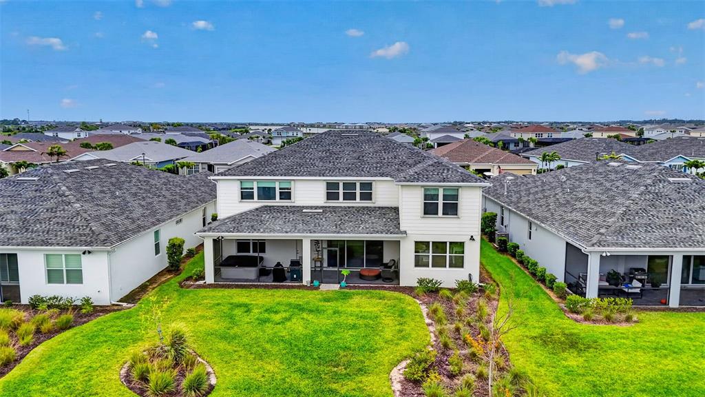 An aerial view of the back of a two-story house with a screened-in patio — 42581 ATLAS DRIVE, PUNTA GORDA, FL