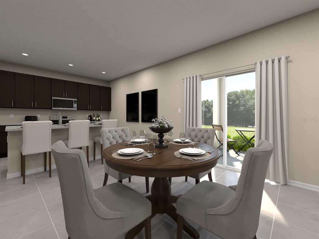 This rendering shows a dining area with a round table and kitchen island — 105 OUTBACK HIDEAWAY AVENUE, NOKOMIS, FL