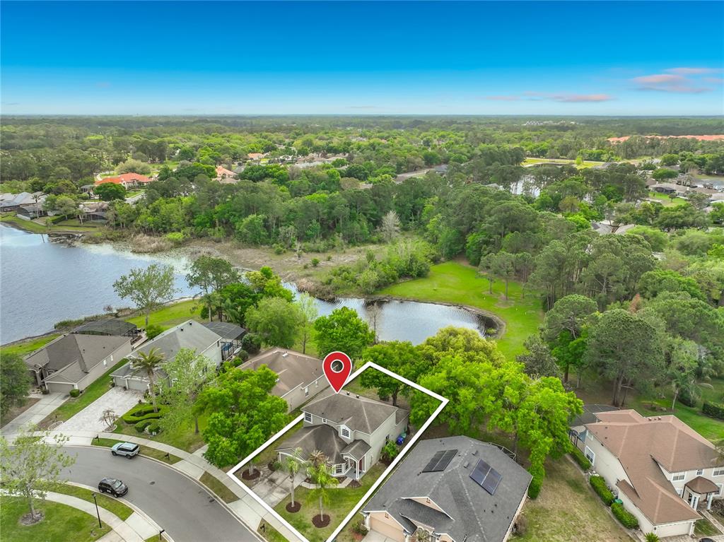 An aerial view shows a suburban house with a white outline and a red pin — 949 PICKFAIR TERRACE, LAKE MARY, FL