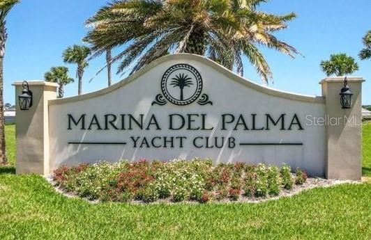 A beige monument sign for Marina Del Palma Yacht Club stands in a grassy area — 34 DEL PALMA DRIVE, PALM COAST, FL