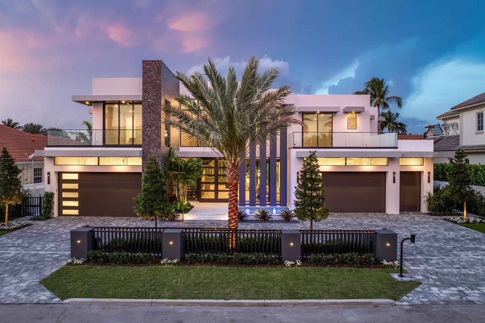 A modern two-story luxury home with a palm tree, three-car garage, and stone-paved driveway — 169 W Coconut Palm Road, Boca Raton FL 33432, BOCA RATON, FL