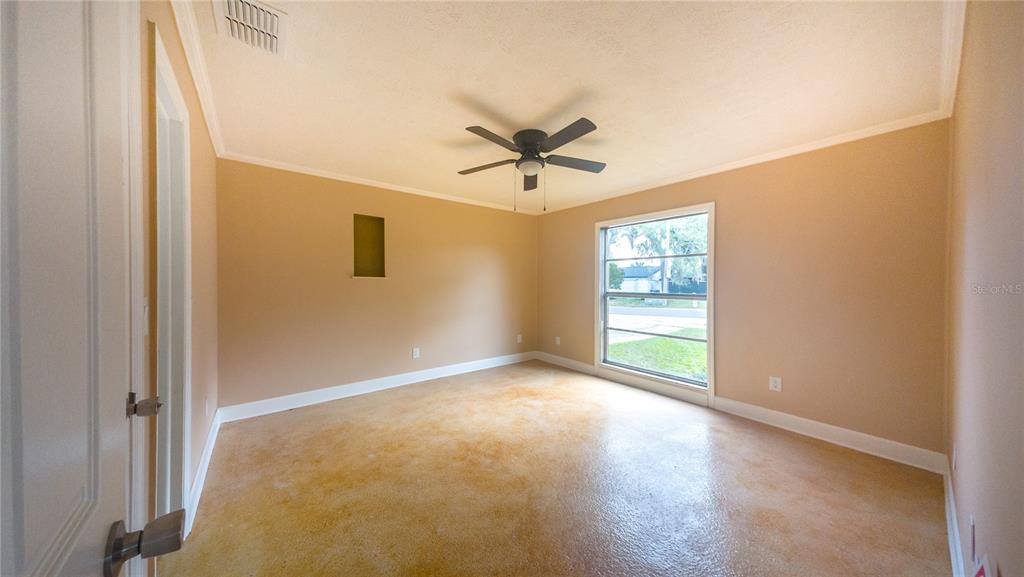 An empty bedroom features tan walls, a ceiling fan, and a stained concrete floor — 3320 LAS BRISAS DRIVE, RIVERVIEW, FL