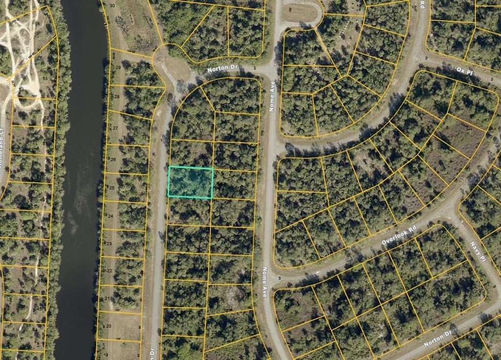This is an aerial map showing a highlighted vacant residential lot in a wooded neighborhood — LOT 9 NORTON DRIVE, NORTH PORT, FL