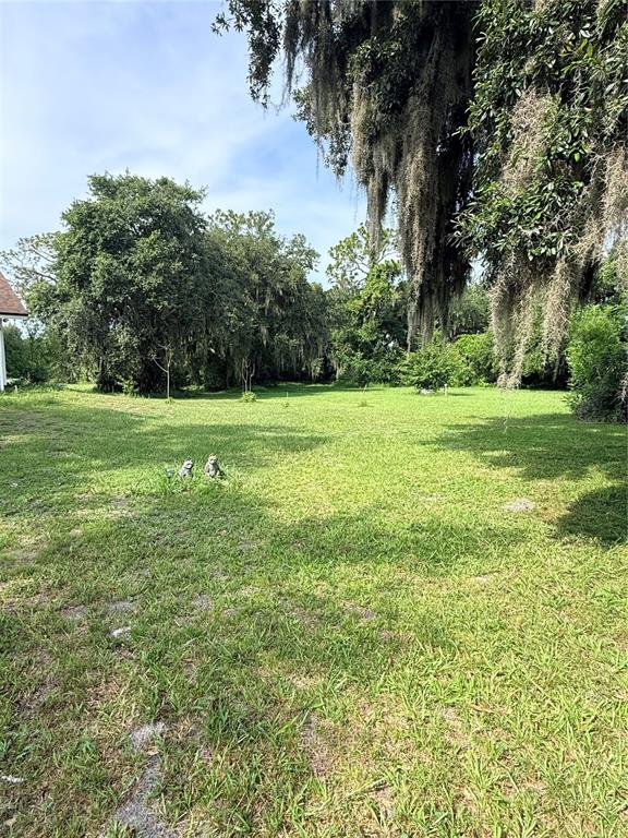 A single-story house with light-colored siding, a front porch, and a white picket fence — 2830 HORTON RD, KISSIMMEE, FL
