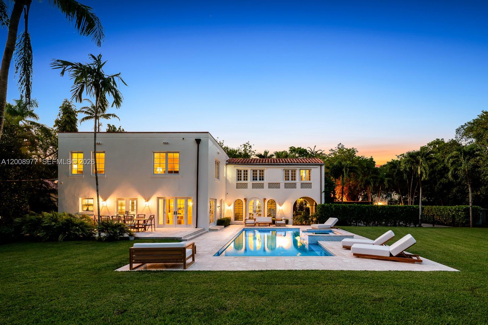 An aerial view of a white two-story house with a swimming pool and large lawn — 1228 Alhambra Cir, Coral Gables FL 33134, CORAL GABLES, FL
