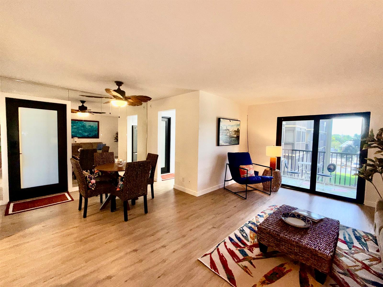 A kitchen features white cabinetry, stainless steel appliances, and a patterned tropical-themed tile backsplash — 2601 NE 14th Street # 340, Pompano Beach FL 33062, POMPANO BEACH, FL