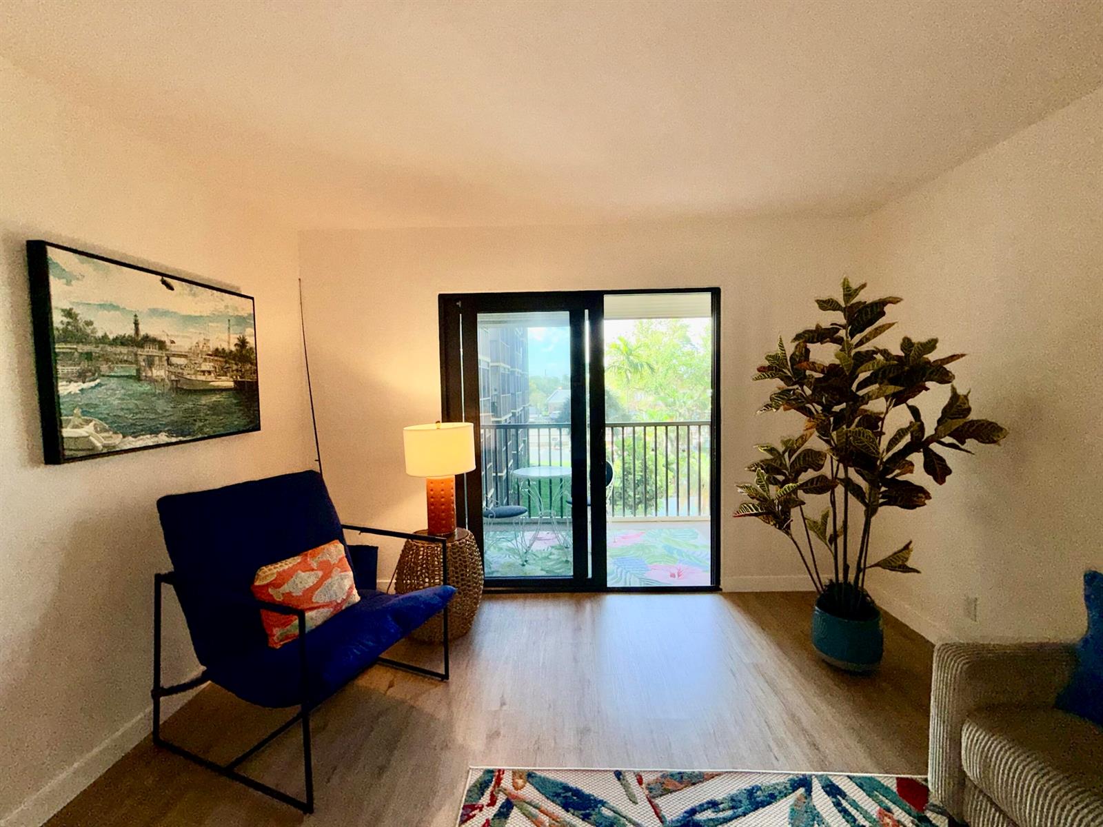 A screened-in balcony features a small bistro table, two chairs, and a floral area rug — 2601 NE 14th Street # 340, Pompano Beach FL 33062, POMPANO BEACH, FL