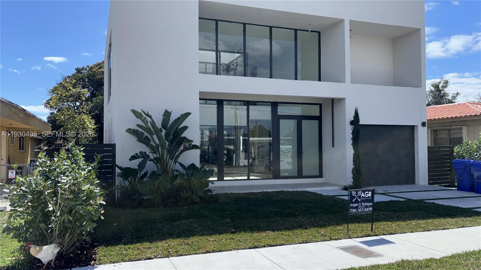 A modern two-story white house with large glass windows and a front lawn — 2484 SW 18th St, Miami FL 33145, MIAMI, FL