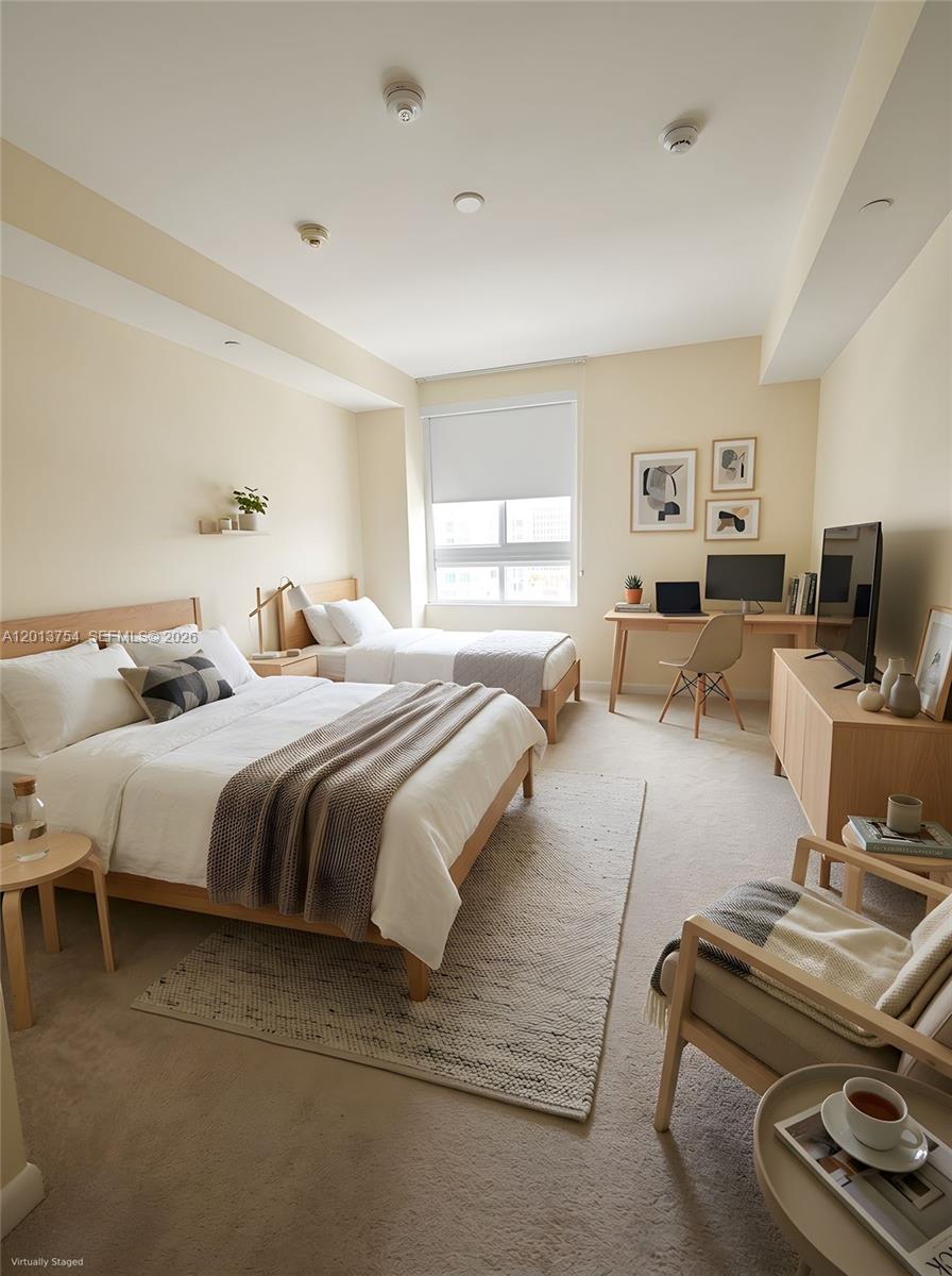 This bedroom features two beds, a desk, a television console, and a seating area — 7350 SW 89th St # 1506S, Miami FL 33156, MIAMI, FL