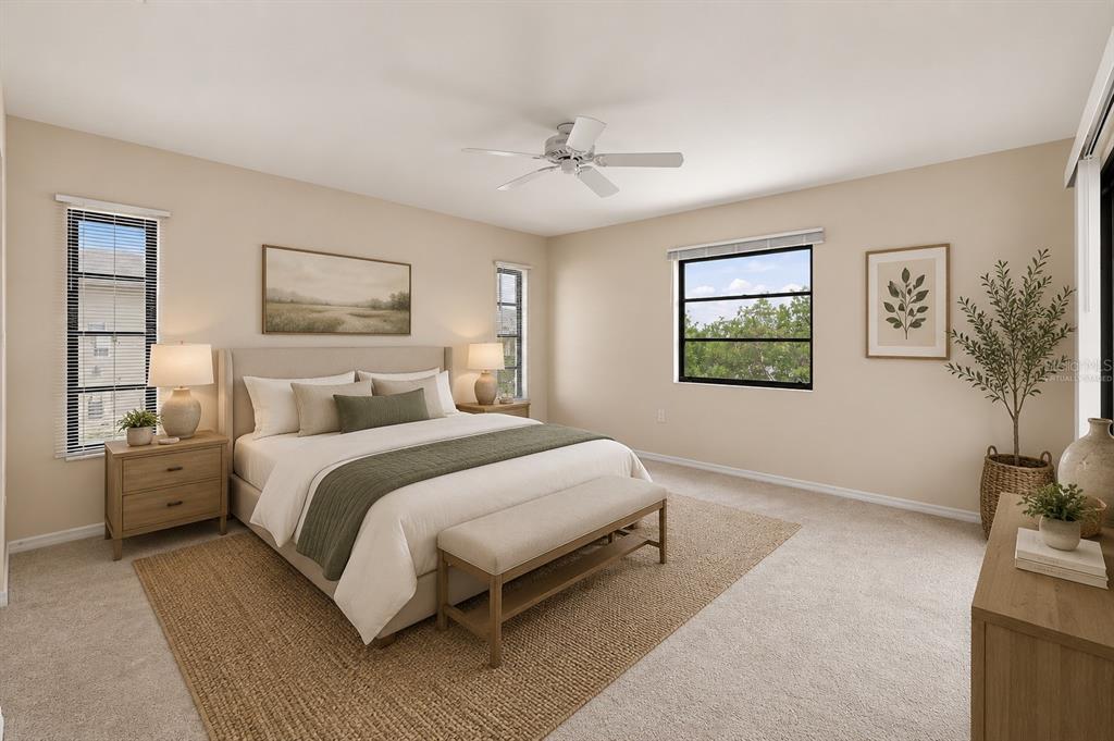 A bedroom with a king bed, neutral walls, a ceiling fan, and large windows — 18422 ARAPAHOE CIRCLE, PORT CHARLOTTE, FL