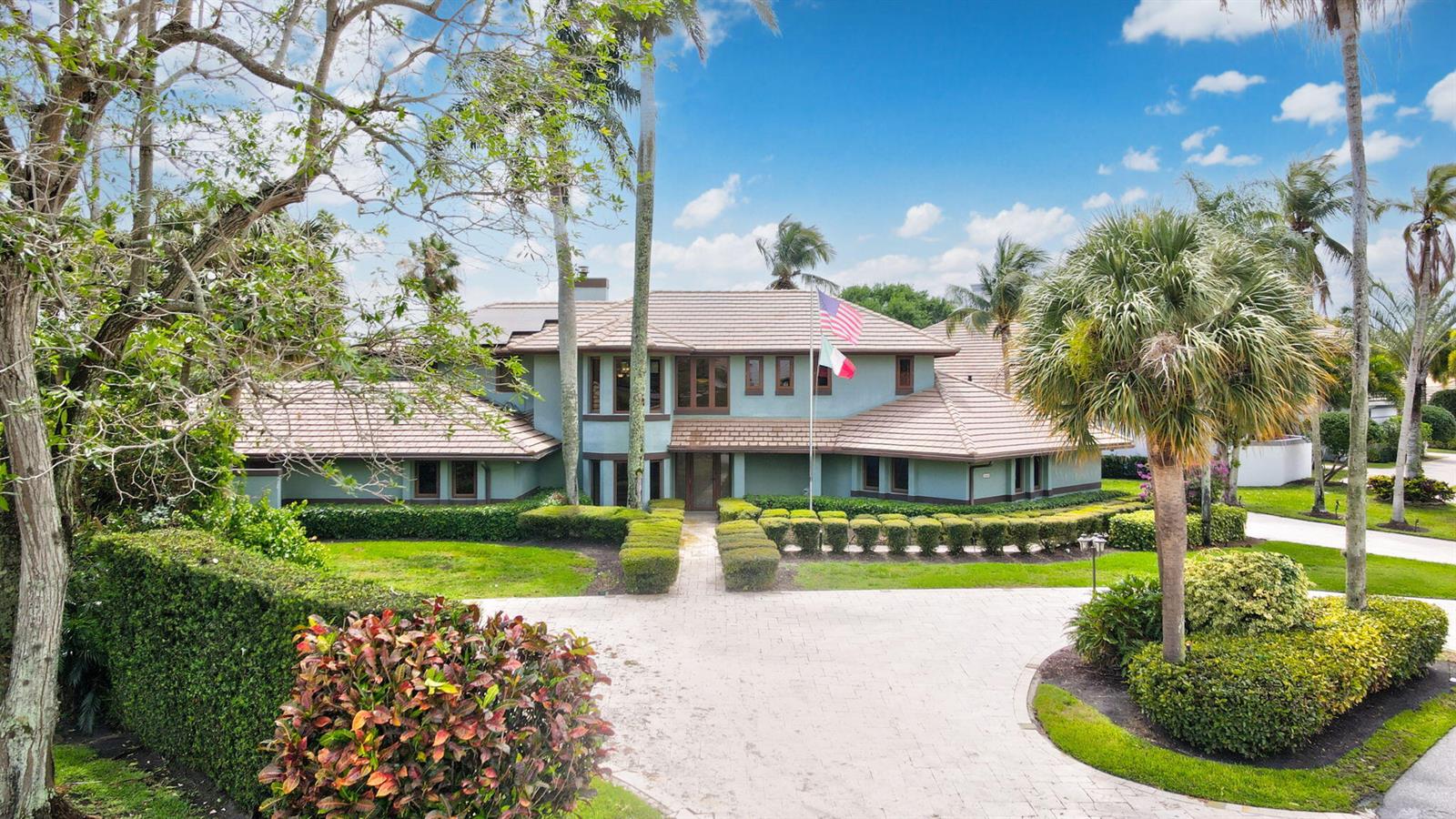 A two-story house with a tiled roof, light green siding, and a paved circular driveway — 4348 Saint Andrews Drive, Boynton Beach FL 33436, BOYNTON BEACH, FL