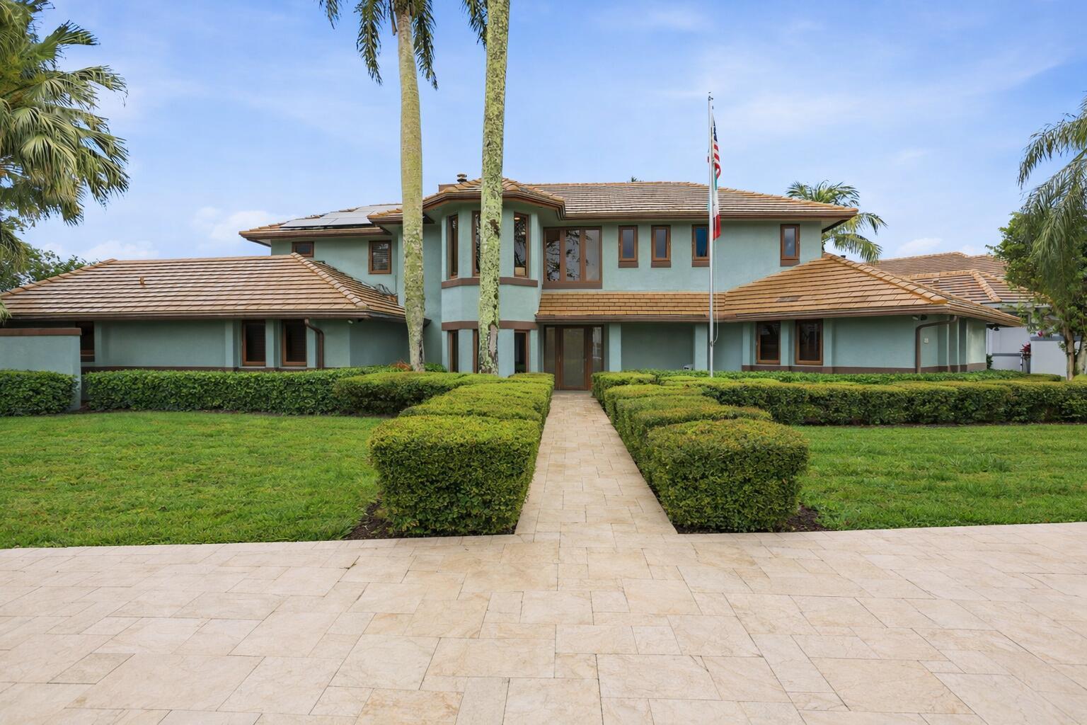 A two-story house with a light green exterior, brown tile roof, and a paved walkway — 4348 Saint Andrews Drive, Boynton Beach FL 33436, BOYNTON BEACH, FL