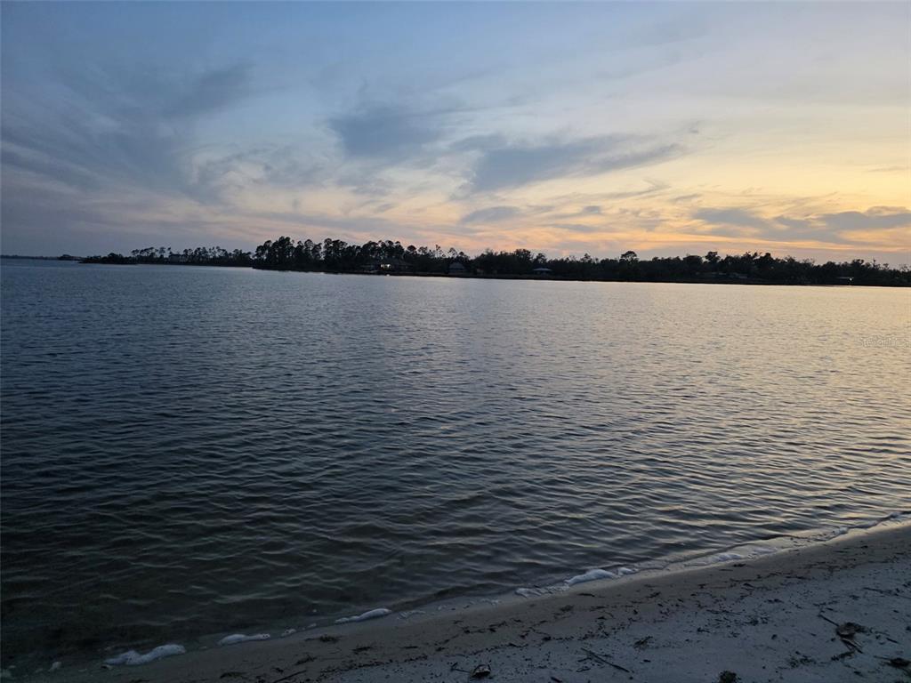 A view of a calm lake at sunset from a sandy shoreline — TBD PLANTATION DRIVE, PANAMA CITY, FL