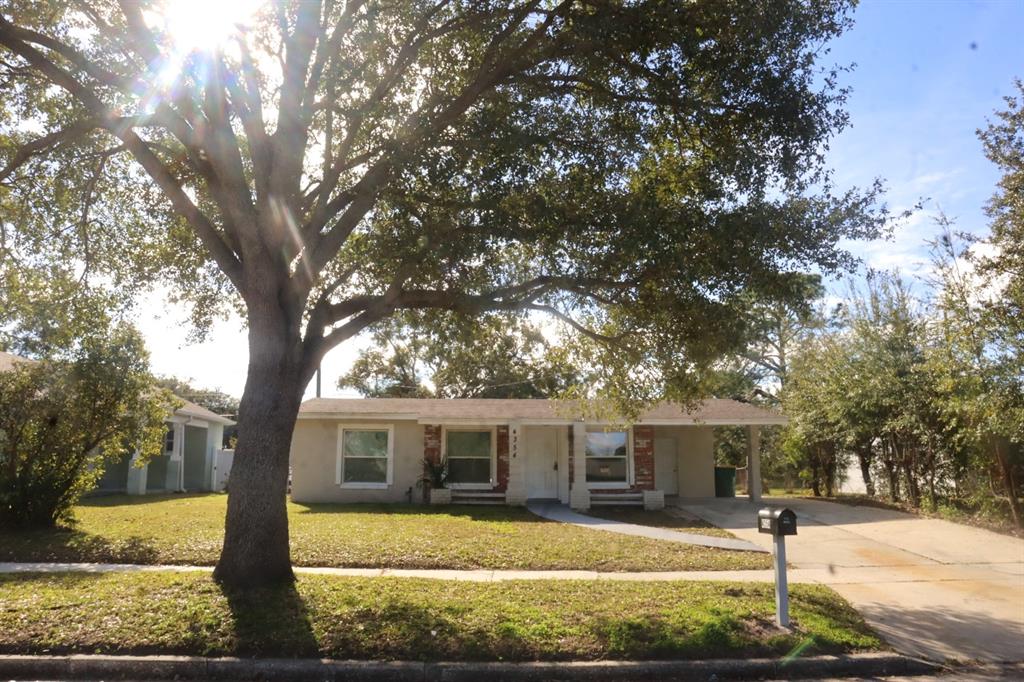 A single-story house with a large tree in the front yard and a carport — 4354 KIRKLAND BOULEVARD, ORLANDO, FL
