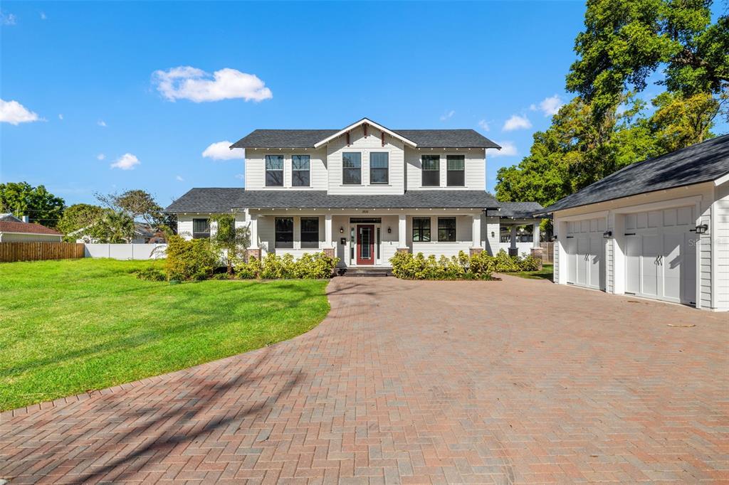 A two-story white house with a brick driveway and a detached garage — 2820 N CENTRAL COURT, TAMPA, FL