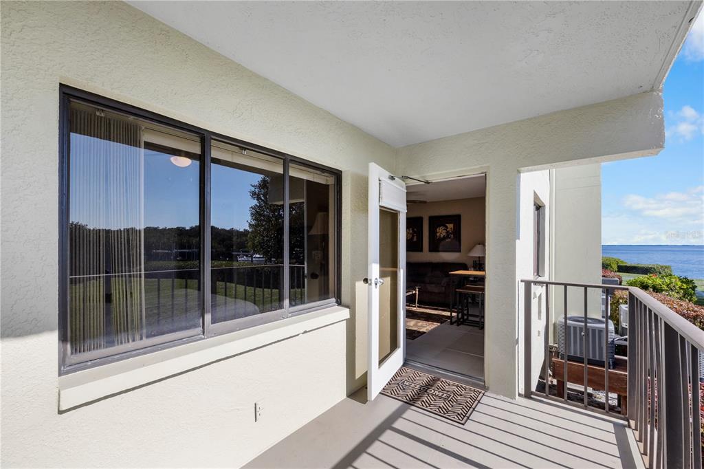 A covered balcony with a metal railing overlooks a body of water — 1515 PINELLAS BAYWAY S UNIT 7, TIERRA VERDE, FL