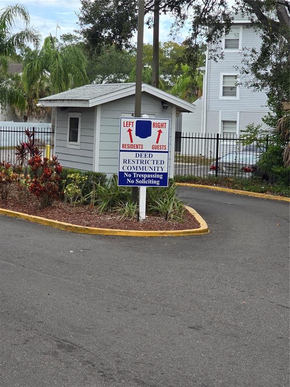 A sign at a gated community entrance directs residents to the left and guests right — 7146 E BANK DRIVE UNIT 7146, TAMPA, FL