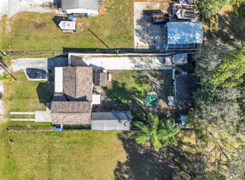 An aerial view shows a house with a shingled roof, a driveway, and a backyard — 3408 RIVER COVE DRIVE, TAMPA, FL