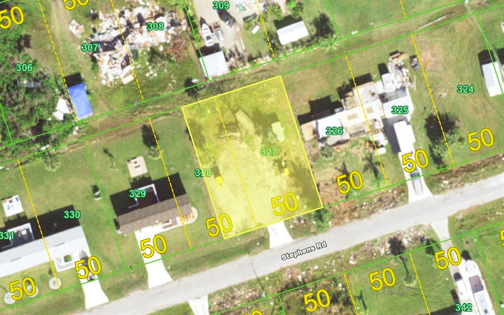 This is an aerial map showing a highlighted rectangular land parcel along a road — 14438 STEPHENS ROAD, PORT CHARLOTTE, FL