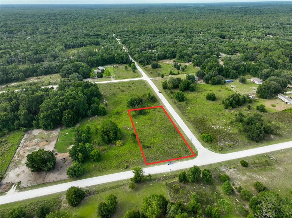 An aerial view shows a vacant rectangular lot outlined in red along a rural road — 9017 SPLIT STONE DRIVE, WEBSTER, FL
