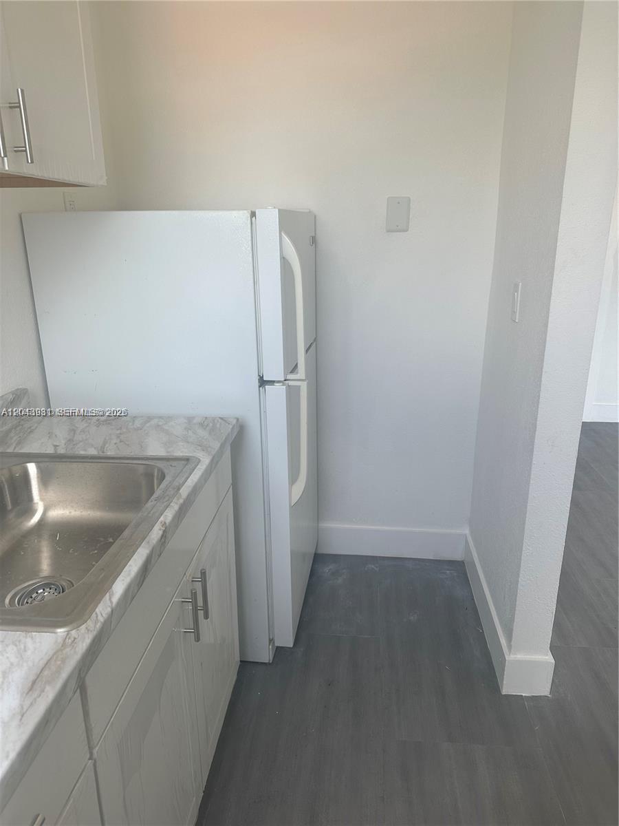 A kitchen features white cabinets, a marble-patterned countertop, a stainless steel sink, and a refrigerator — 2961 SW 5th St # 21, Miami FL 33135, MIAMI, FL