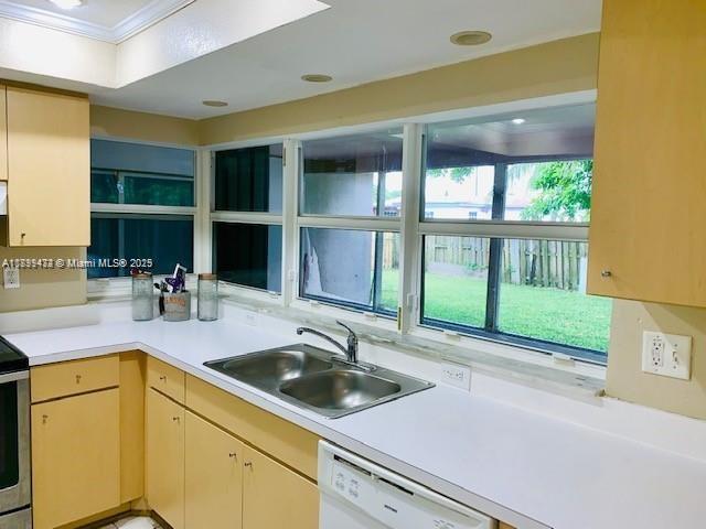 A kitchen features light wood cabinets, white countertops, a double sink, and large windows — 6720 NW 28th St, Sunrise FL 33313, SUNRISE, FL