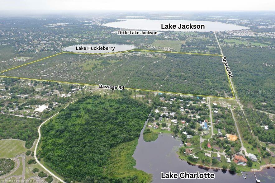 This aerial view shows a large, undeveloped parcel of land outlined in yellow near several lakes — 5525 SPARTA ROAD UNIT B, SEBRING, FL