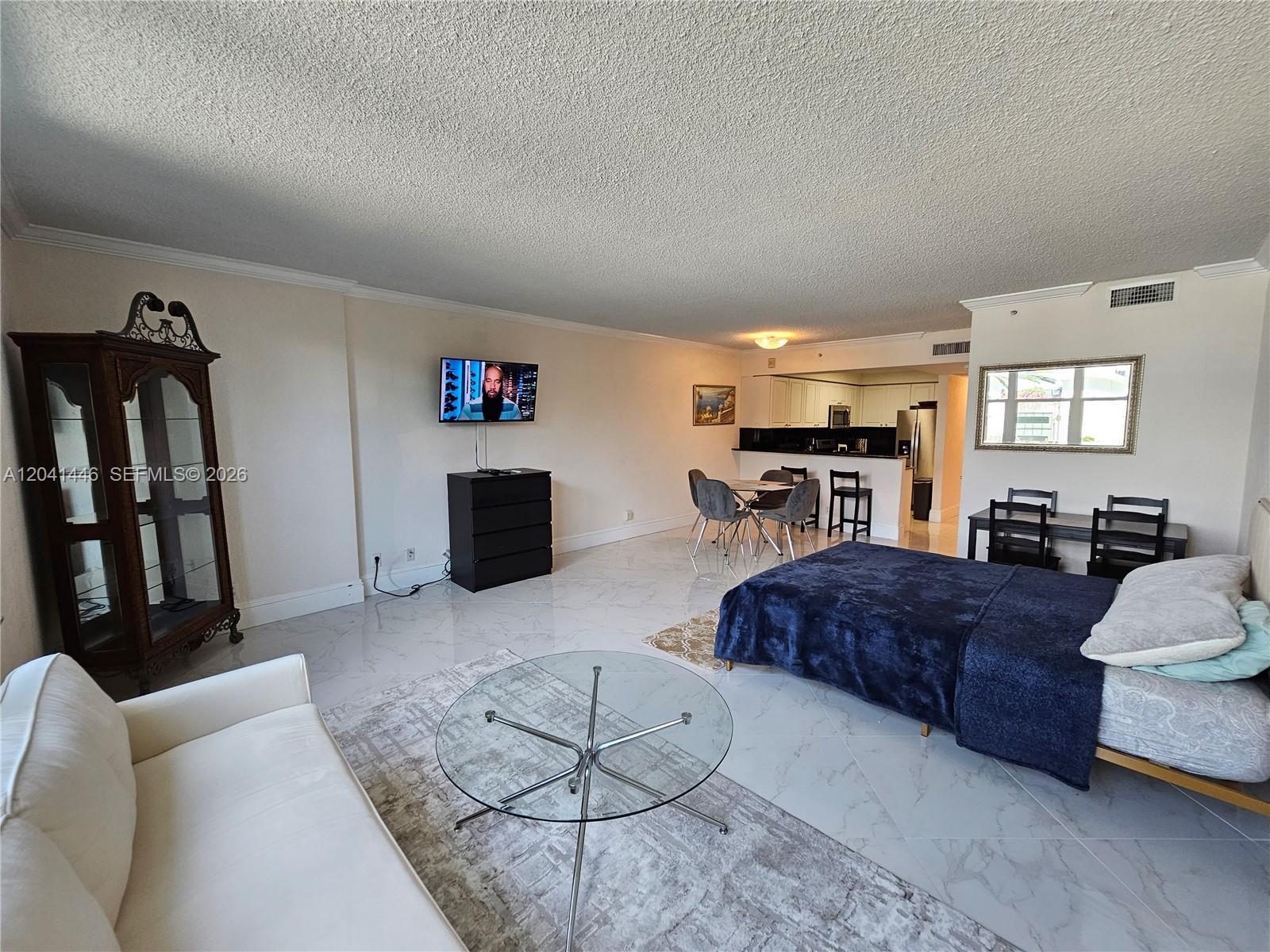 This studio apartment features a bed, living area, dining space, and kitchen with tiled floors — 2501 S Ocean Dr # 327, Hollywood FL 33019, HOLLYWOOD, FL