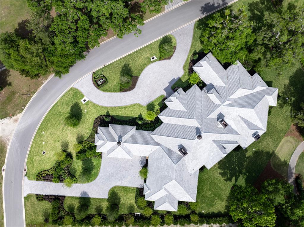 An aerial view shows a large house with a complex roofline and a paved driveway — 8707 NW 31ST LANE ROAD, OCALA, FL