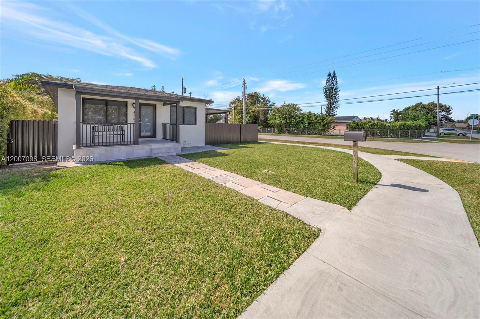 A single-story house with a front porch, stone walkway, and lawn under a blue sky — 7470 SW 37th St, Miami FL 33155, MIAMI, FL