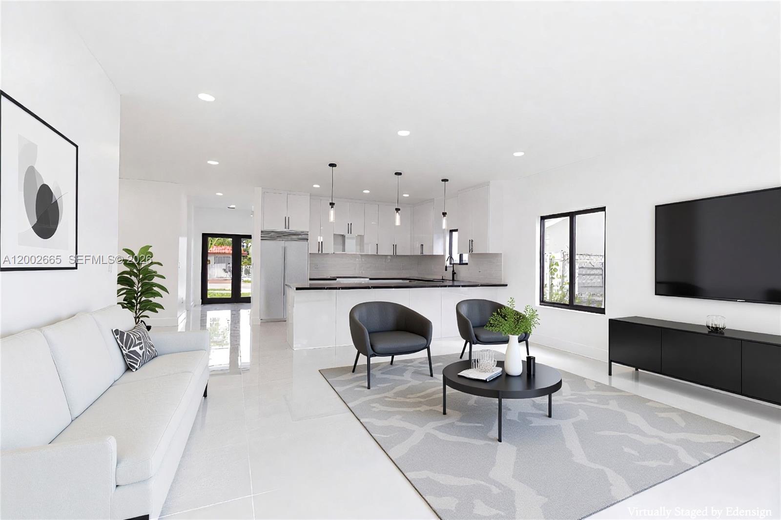This open-concept living room features white tile floors, a modern kitchen, and a television console — 5550 SW 4th St, Miami FL 33134, MIAMI, FL