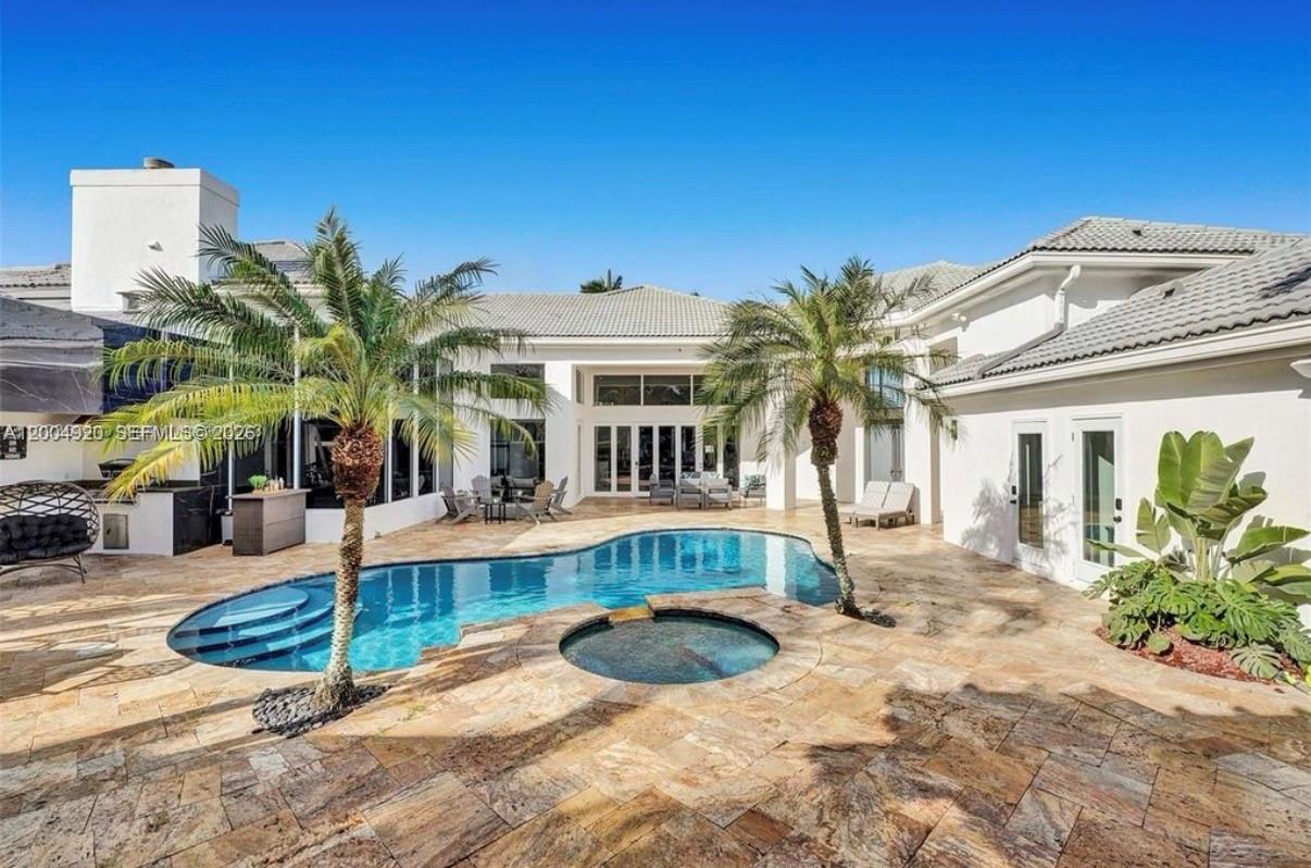A backyard features a swimming pool, a hot tub, and two palm trees — 11400 NW 7th St, Plantation FL 33325, PLANTATION, FL