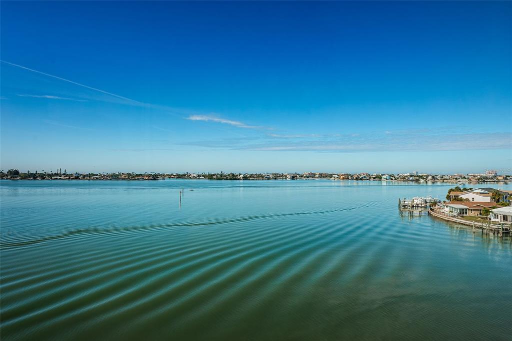 An elevated view of a calm bay with ripples on the water and distant houses — 4750 COVE CIRCLE UNIT 605, ST PETERSBURG, FL