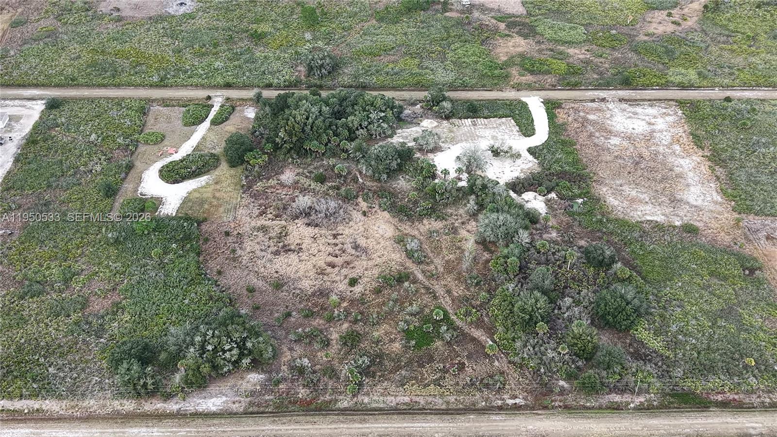 An aerial view shows a vacant, partially cleared plot of land with some vegetation — 21867 NW 276TH, Okeechobee FL 34972, OKEECHOBEE, FL
