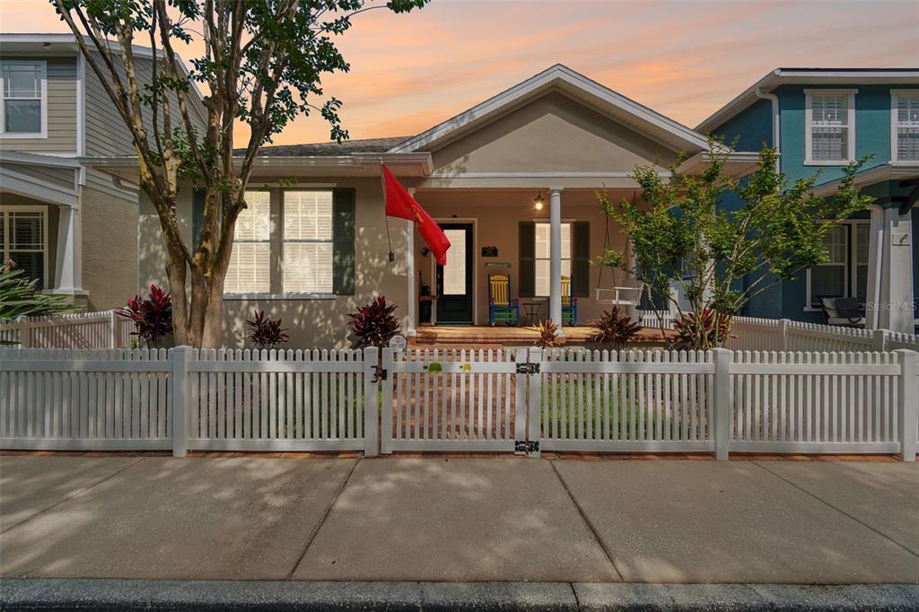 A single-story house with a white picket fence, a front porch, and a red flag — 3550 FERRELL STREET, NEW PORT RICHEY, FL