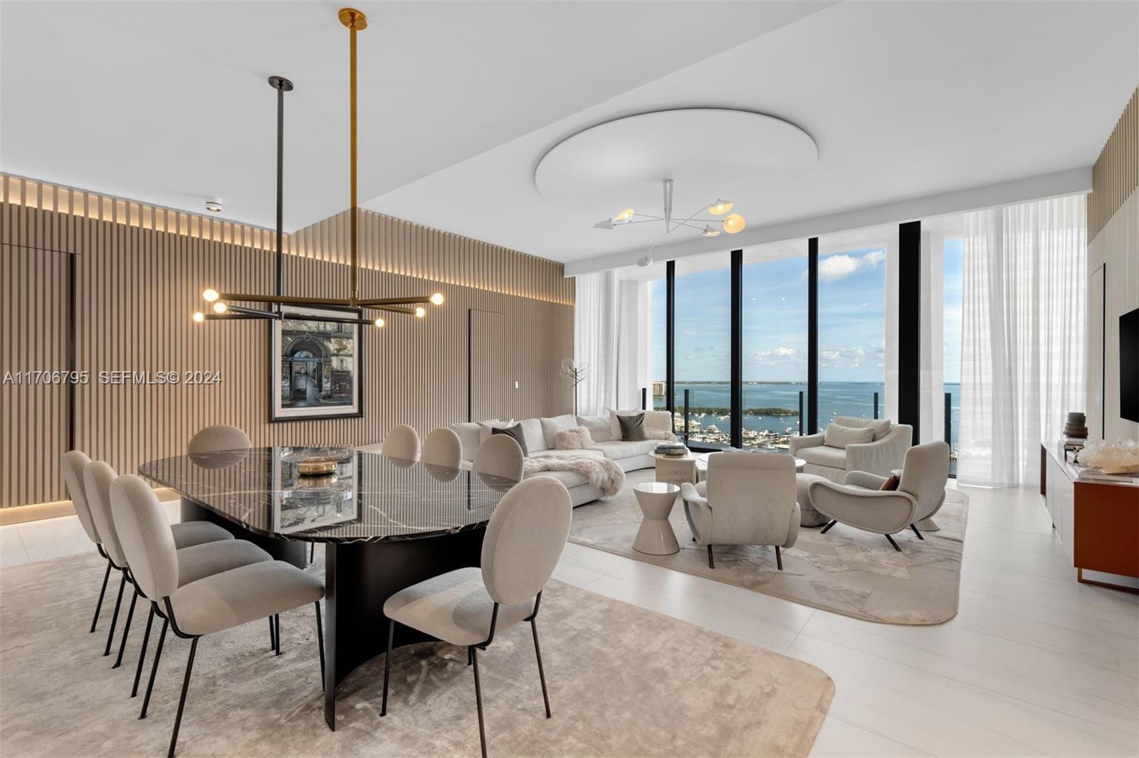 A modern open-concept living and dining room features floor-to-ceiling windows with a waterfront view — 2811 S Bayshore Dr, Miami FL 33133, MIAMI, FL
