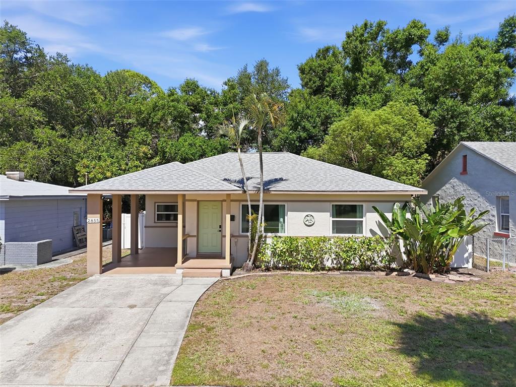 A single-story house with a light-colored exterior, a front porch, and a concrete driveway — 2855 VALENCIA WAY S, ST PETERSBURG, FL
