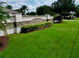 A stone and stucco monument sign for Osprey Ridge sits on a manicured green lawn — 0 ELOISE LOOP ROAD, WINTER HAVEN, FL