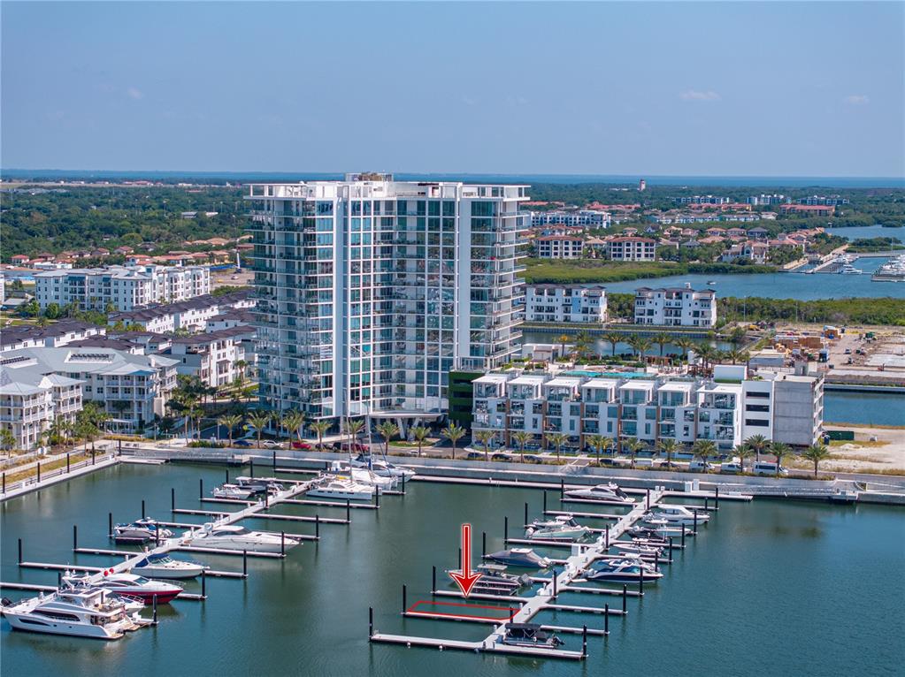 An aerial view shows a marina with a red arrow pointing to an empty boat slip — 5120 MARINA WAY UNIT D-E-16, TAMPA, FL