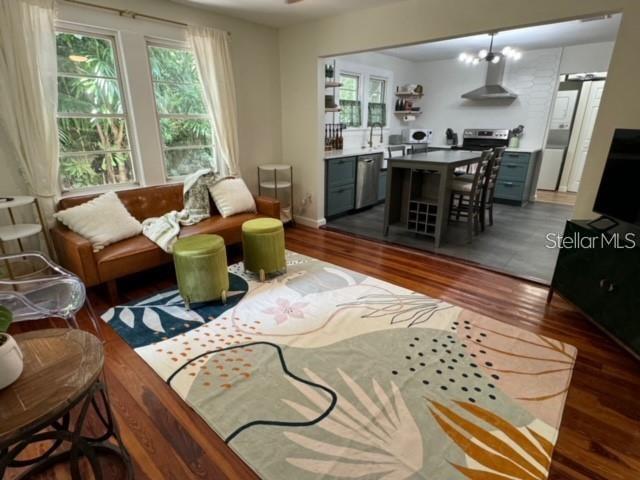A living room with hardwood floors opens into a kitchen featuring a central island — 1410 W HUMPHREY STREET, TAMPA, FL