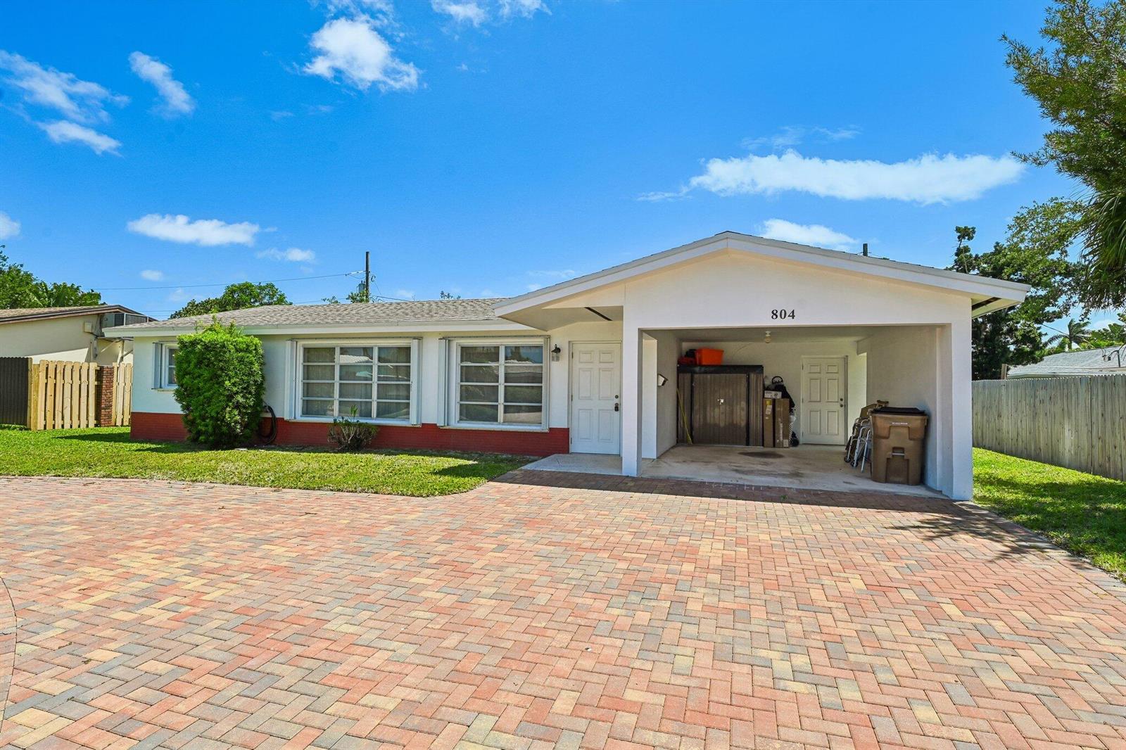 A single-story house with a brick-paved driveway, a carport, and a white exterior — 804 SE 16th Court, Deerfield Beach FL 33441, DEERFIELD BEACH, FL