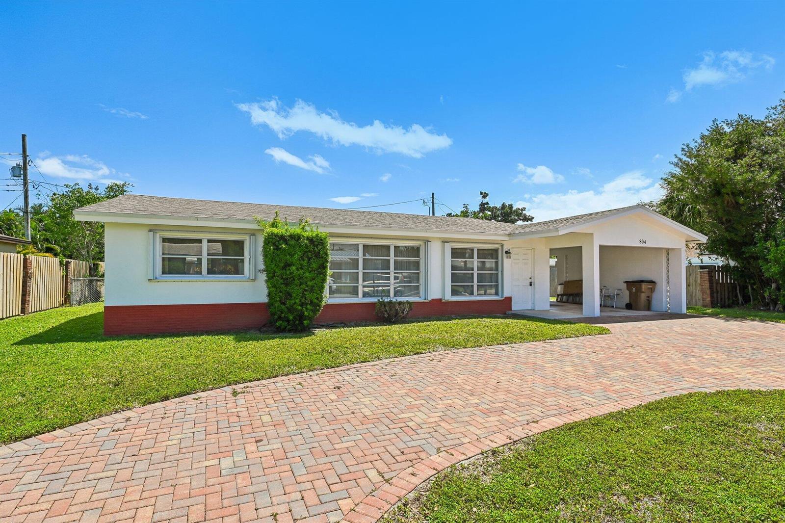 A single-story house with a brick-paved driveway, a carport, and a red-painted base — 804 SE 16th Court, Deerfield Beach FL 33441, DEERFIELD BEACH, FL