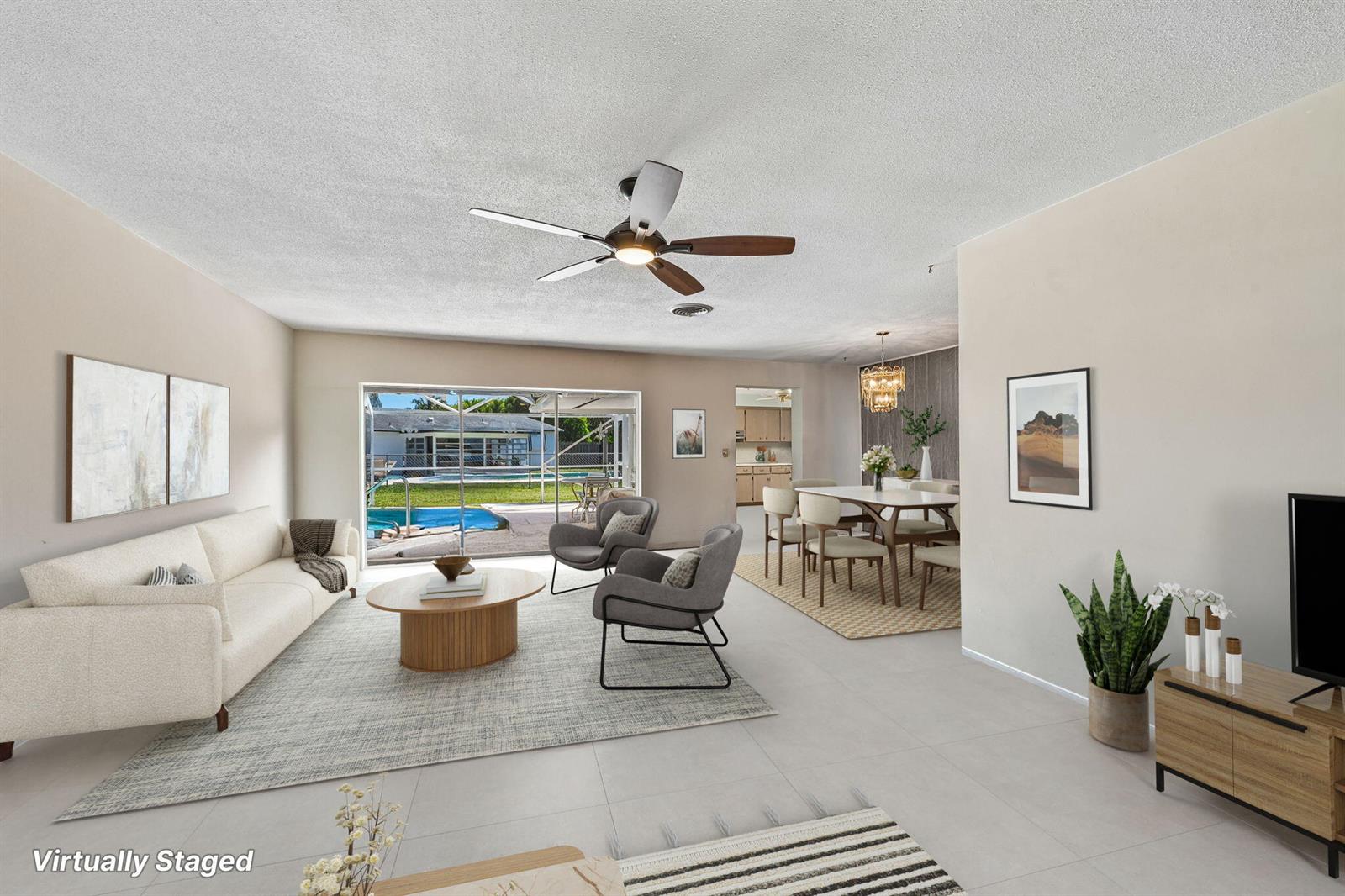 A virtually staged living and dining area features tile floors, a ceiling fan, and pool views — 804 SE 16th Court, Deerfield Beach FL 33441, DEERFIELD BEACH, FL