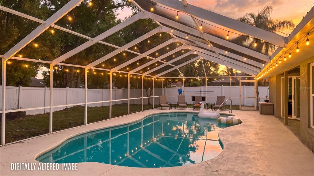 A single-story house with a two-car garage and arched windows at dusk — 707 POWDER HORN ROW, LAKELAND, FL