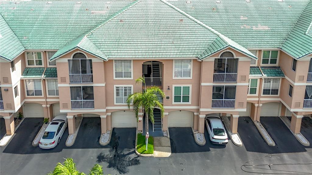 An aerial view of a multi-story apartment building with a green tiled roof — 5308 BAY CLUB CIRCLE UNIT 5308, TAMPA, FL