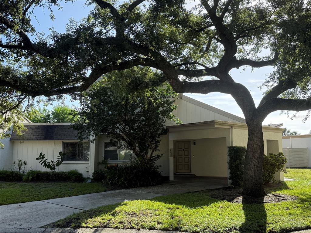 A two-story house with a carport, a large tree in the front yard, and siding — 2641 CEDAR VIEW COURT, CLEARWATER, FL