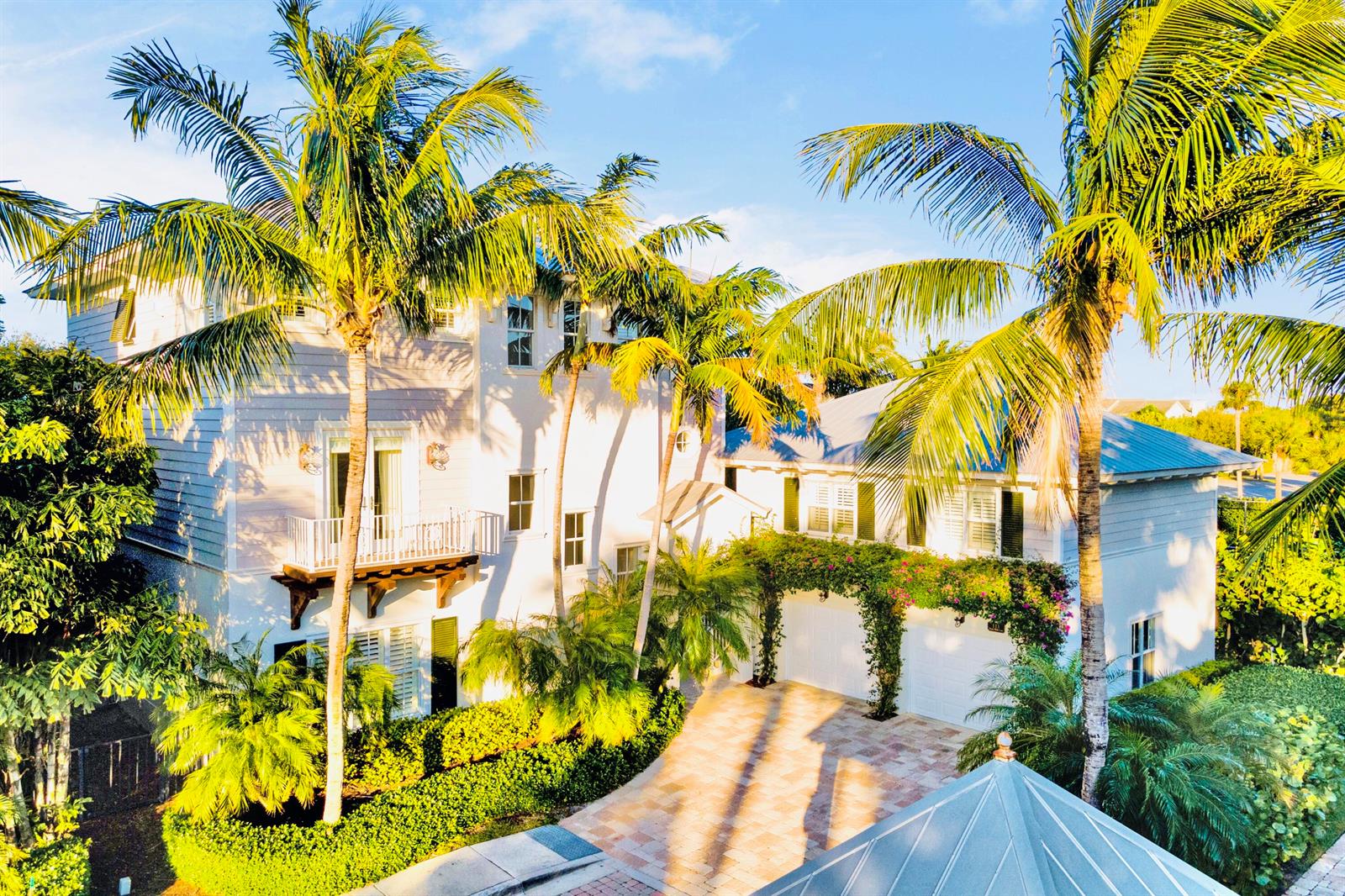 A multi-story white house with a balcony, palm trees, and a paved driveway — 111 Beachwalk Lane, Jupiter FL 33477, JUPITER, FL