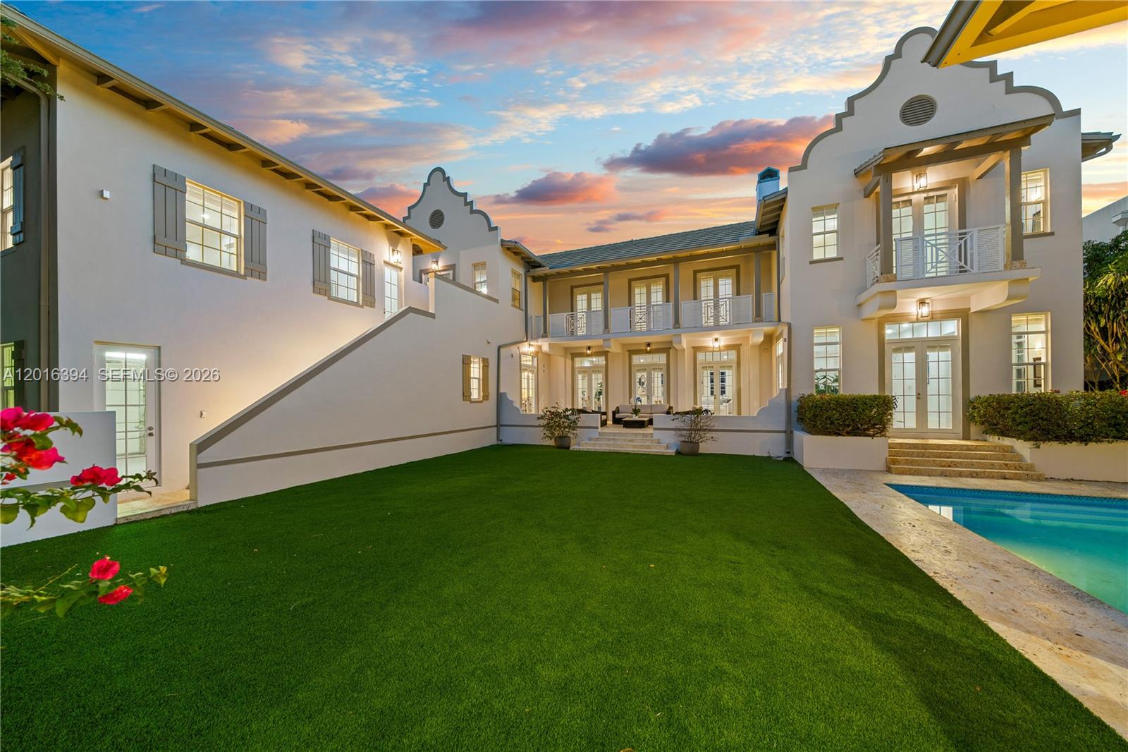 A two-story stucco house with a backyard lawn, swimming pool, and second-floor balcony — 7745 SW 54th Ave, Miami FL 33143, MIAMI, FL