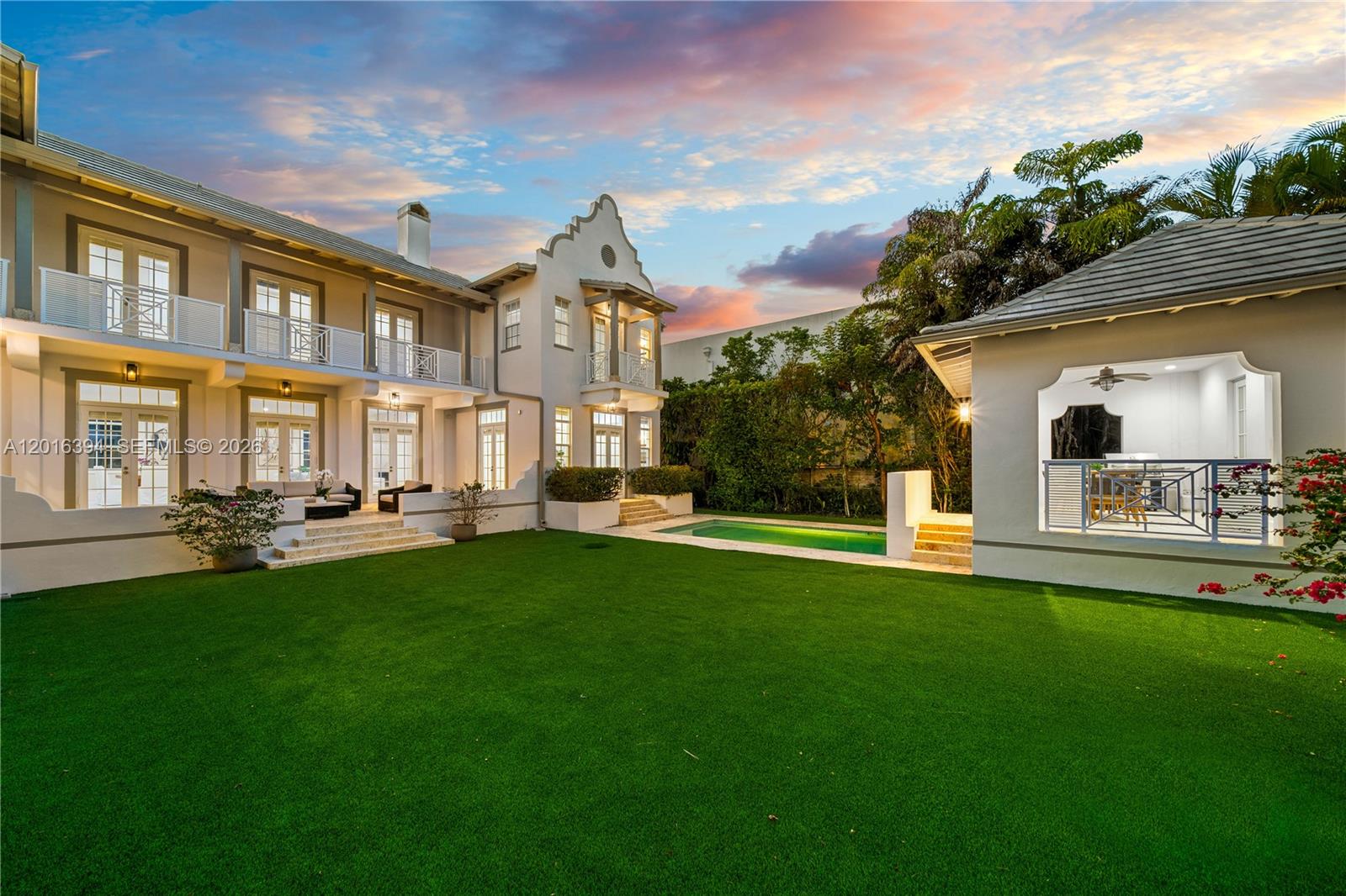 A two-story house with a pool and a detached covered patio overlooks a grassy lawn — 7745 SW 54th Ave, Miami FL 33143, MIAMI, FL